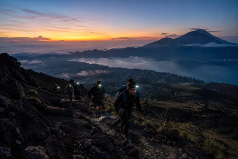 Hikers climbing Mount Batur before sunrise on the volcanic trail